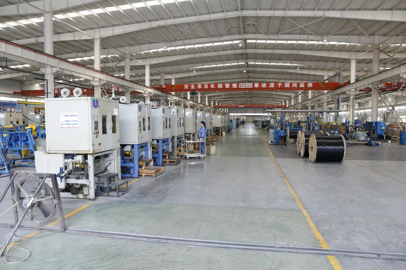 Cable production line with extruders and haul-off equipment along the workshop aisle