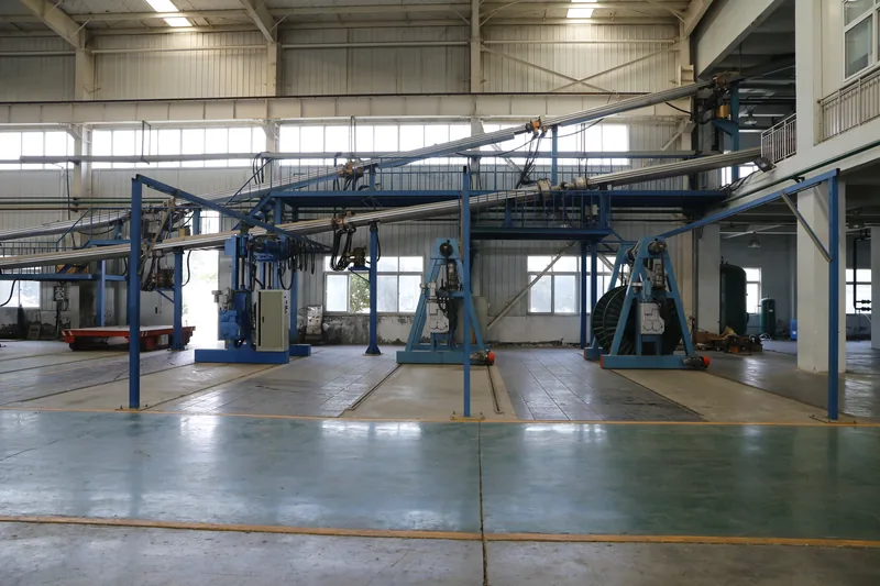 Overhead conductor feed gantries above the screening and armouring area