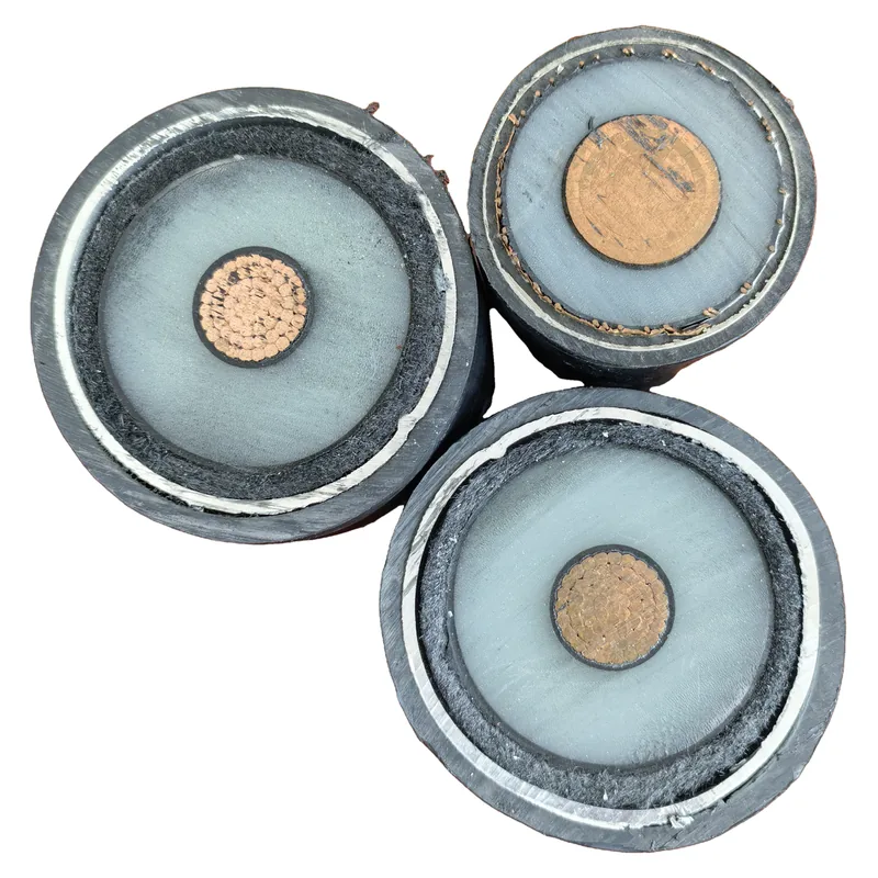 Cut ends of three single-core cables standing together — each with a stranded copper conductor, a dark layer, a thick light grey layer, a bright metallic tape and a black outer sheath